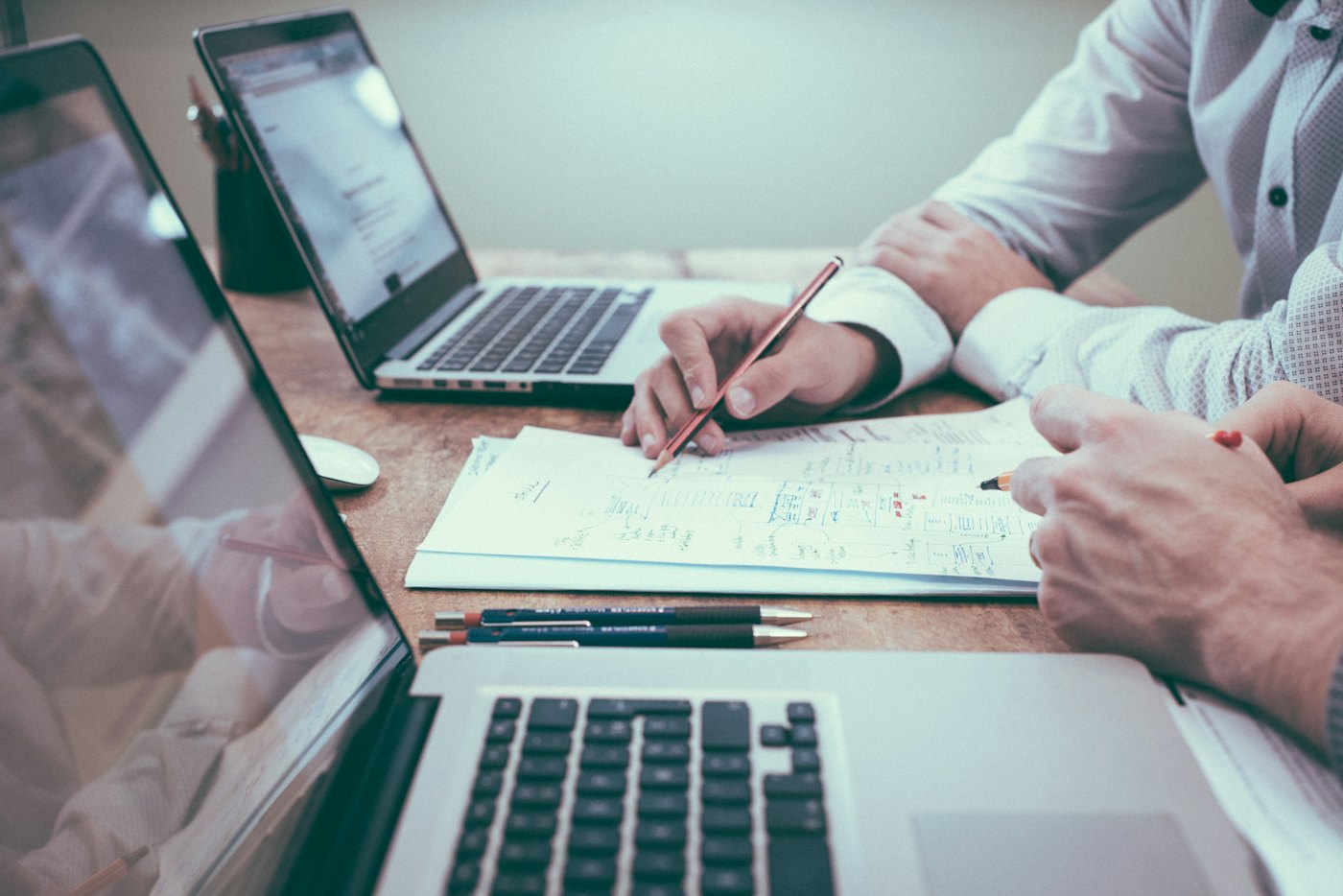 Two people reviewing a printed plan at a desk