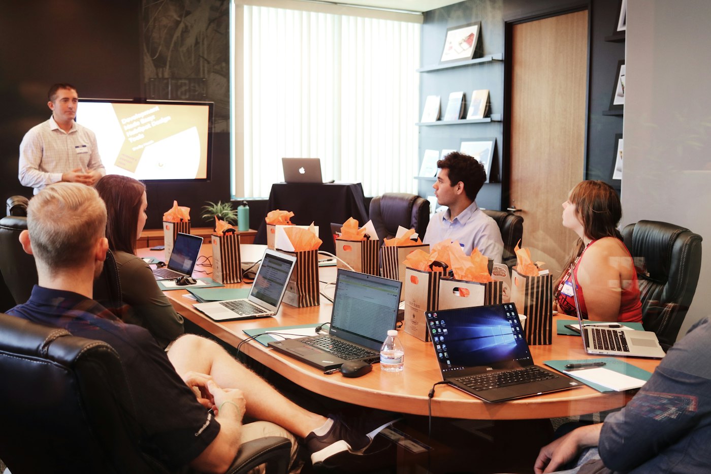 A trainer presenting to a group around a table